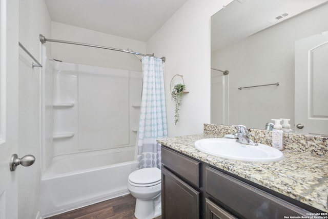 6631 Rosenthal Pass, San Antonio, TX 78252 - bathroom featuring wood finished floors, vanity, toilet, and shower / tub combo with curtain