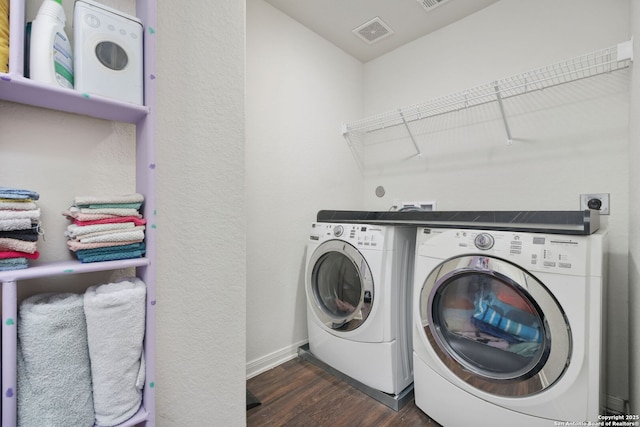 6631 Rosenthal Pass, San Antonio, TX 78252 - laundry room with washing machine and clothes dryer, dark wood-type flooring, and baseboards