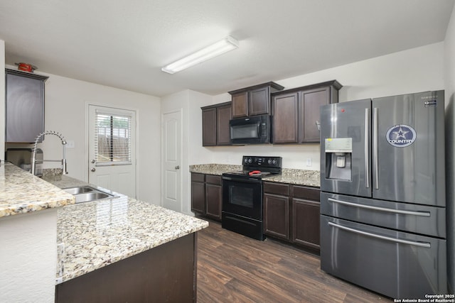 6631 Rosenthal Pass, San Antonio, TX 78252 - kitchen featuring black appliances, dark brown cabinets, dark wood-style flooring, a sink, and light stone counters