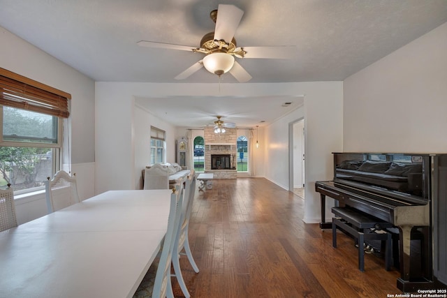 109 Briarwood, Kerrville, TX 78028 - dining area featuring dark wood-type flooring, healthy amount of natural light, a fireplace, and a ceiling fan