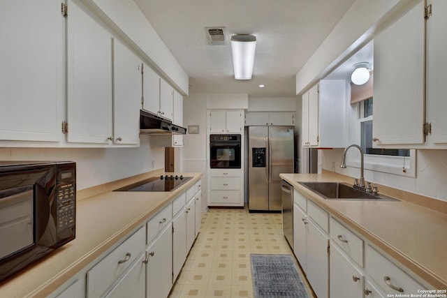 109 Briarwood, Kerrville, TX 78028 - kitchen featuring black appliances, a sink, light flooring, under cabinet range hood, and white cabinets