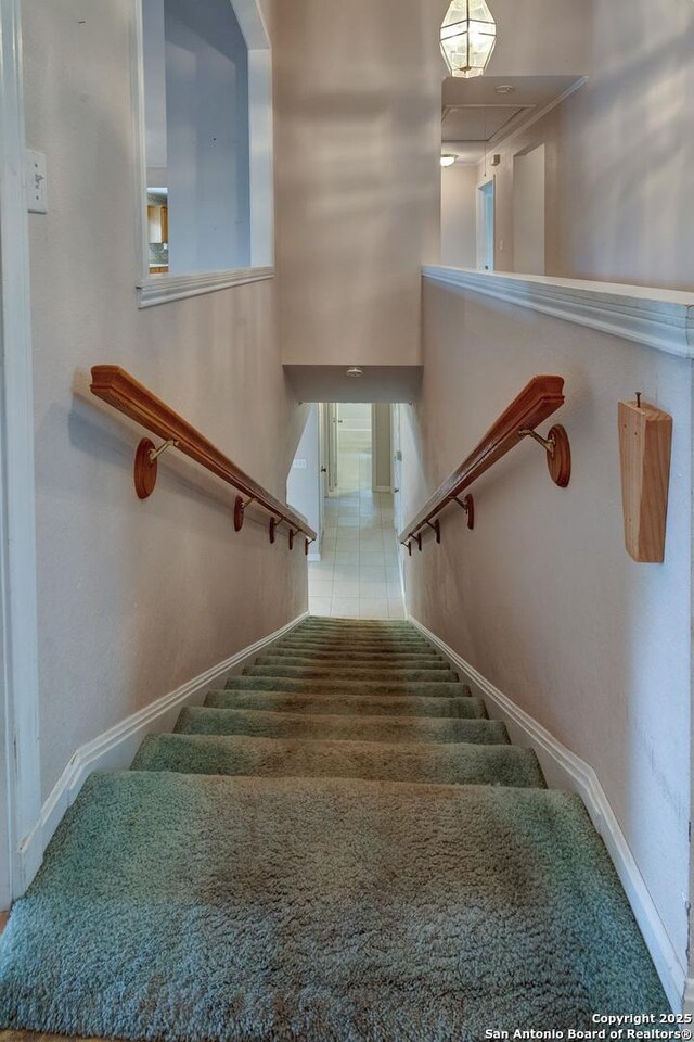 1306 Lytle, Kerrville, TX 78028 - stairway with attic access, baseboards, and carpet