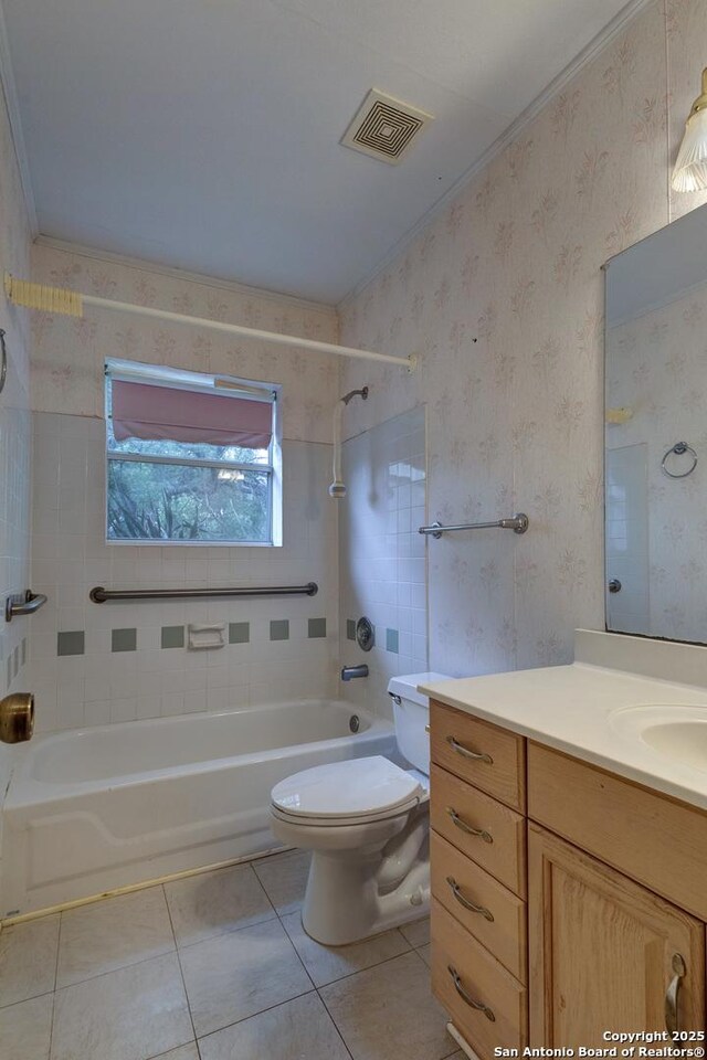1306 Lytle, Kerrville, TX 78028 - full bath with tile patterned floors, shower / washtub combination, toilet, vanity, and wallpapered walls