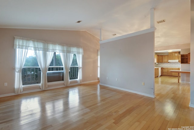 1306 Lytle, Kerrville, TX 78028 - spare room featuring vaulted ceiling, light wood-style flooring, and baseboards