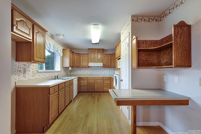 1306 Lytle, Kerrville, TX 78028 - kitchen featuring open shelves, a sink, white appliances, light wood finished floors, and a peninsula