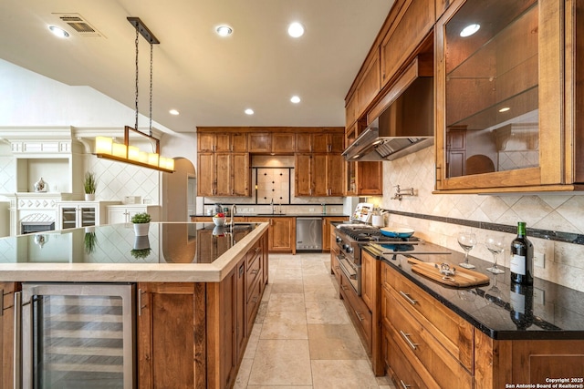 19223 Terra Rock, San Antonio, TX 78255 - kitchen featuring wine cooler, brown cabinetry, tasteful backsplash, and recessed lighting