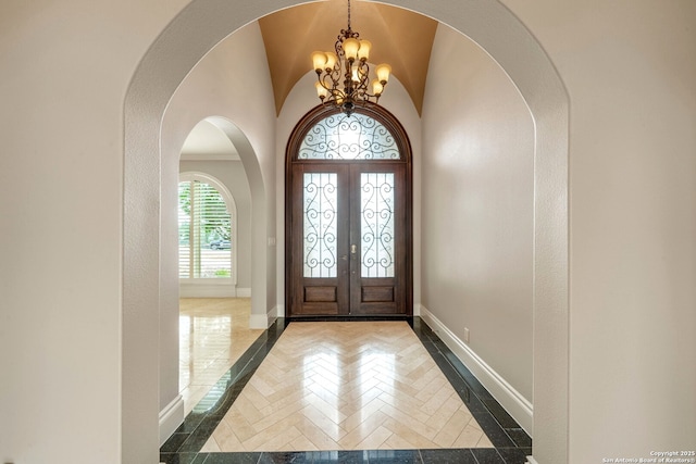 19223 Terra Rock, San Antonio, TX 78255 - entrance foyer with inlaid floor details, a chandelier, baseboards, arched walkways, and french doors