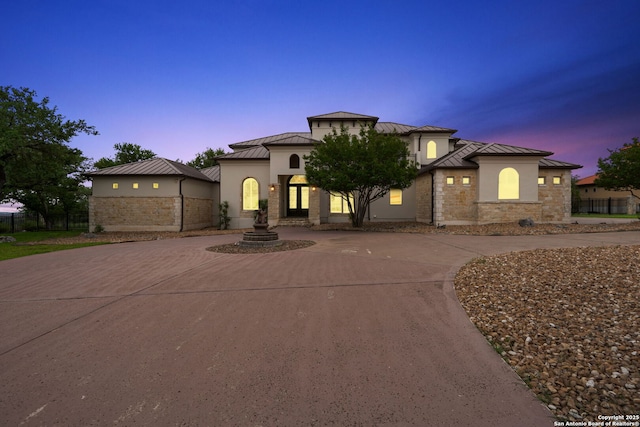 19223 Terra Rock, San Antonio, TX 78255 - mediterranean / spanish-style house with a standing seam roof, curved driveway, metal roof, stucco siding, and stone siding