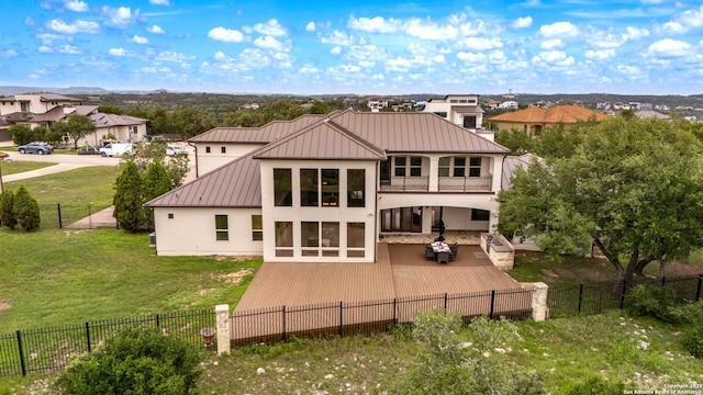 19223 Terra Rock, San Antonio, TX 78255 - back of house with a standing seam roof, stucco siding, a balcony, metal roof, and a patio