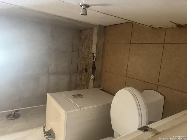 3711 Southport, San Antonio, TX 78223 - bathroom featuring toilet and tile walls