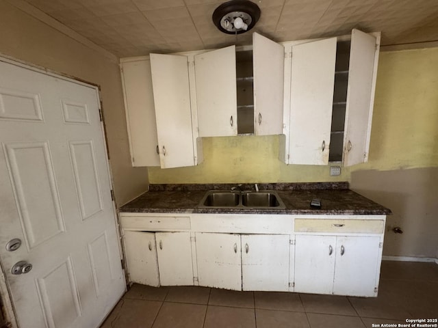 3711 Southport, San Antonio, TX 78223 - kitchen featuring a sink, tile patterned flooring, and white cabinetry