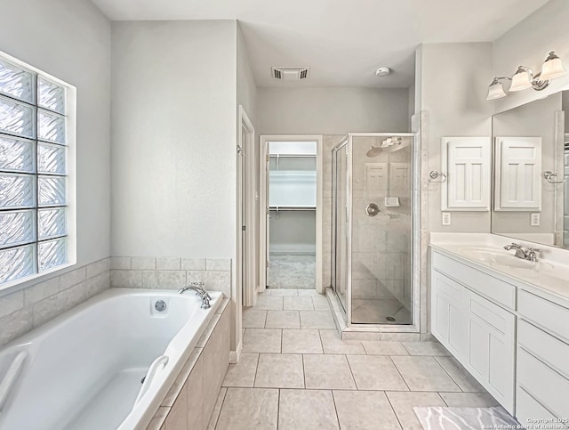 106 Serenity, Boerne, TX 78006 - bathroom with a stall shower, tile patterned flooring, a garden tub, vanity, and a spacious closet