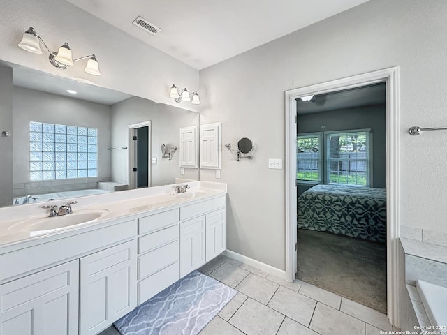 106 Serenity, Boerne, TX 78006 - ensuite bathroom with tile patterned flooring, double vanity, a garden tub, and baseboards