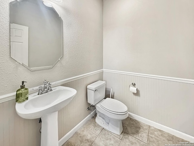 106 Serenity, Boerne, TX 78006 - half bathroom featuring tile patterned flooring, toilet, and a sink