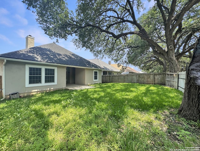 106 Serenity, Boerne, TX 78006 - back of house featuring a chimney, stucco siding, and a shingled roof