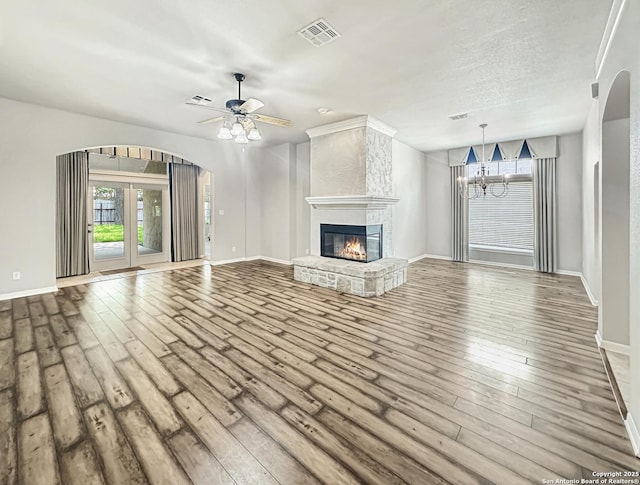 106 Serenity, Boerne, TX 78006 - unfurnished living room with hardwood / wood-style flooring, ceiling fan, a chandelier, and baseboards