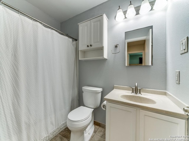 16402 Blanco Ky, San Antonio, TX 78247 - full bath featuring toilet, vanity, tile patterned floors, and baseboards