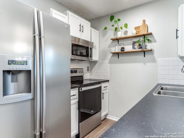 16402 Blanco Ky, San Antonio, TX 78247 - kitchen featuring stainless steel appliances, a sink, white cabinetry, open shelves, and decorative backsplash