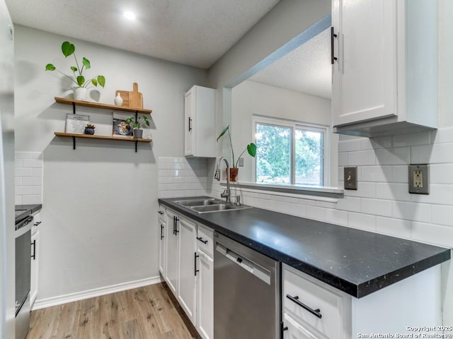 16402 Blanco Ky, San Antonio, TX 78247 - kitchen with stainless steel dishwasher, a sink, decorative backsplash, white cabinetry, and dark countertops