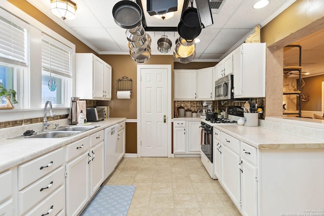 859 Pine St, New Braunfels, TX 78130 - kitchen with white appliances, a sink, decorative backsplash, and white cabinets