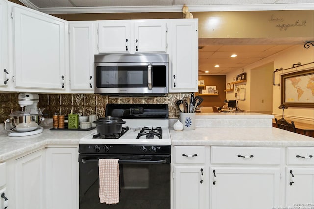 859 Pine St, New Braunfels, TX 78130 - kitchen featuring stainless steel microwave, gas range, white cabinetry, tasteful backsplash, and recessed lighting