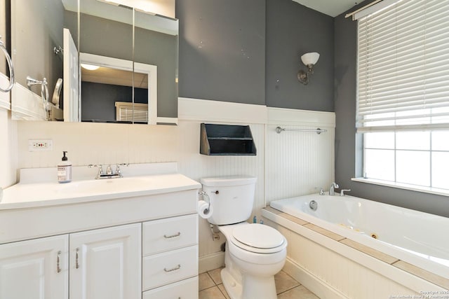 859 Pine St, New Braunfels, TX 78130 - bathroom with a whirlpool tub, toilet, vanity, tile patterned floors, and wainscoting