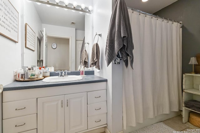 859 Pine St, New Braunfels, TX 78130 - bathroom with tile patterned floors, vanity, and curtained shower