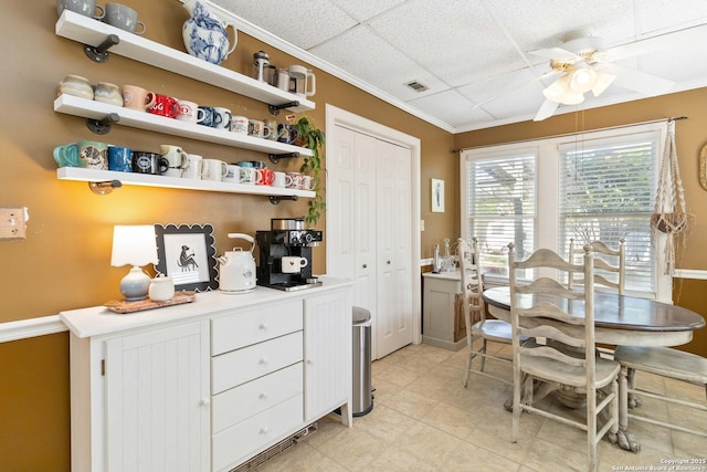 859 Pine St, New Braunfels, TX 78130 - dining space featuring ceiling fan, crown molding, light tile patterned floors, and a paneled ceiling