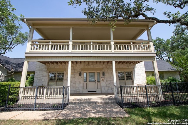 8333 Triple Crown, Boerne, TX 78015 - back of house with a balcony, covered porch, and stone siding