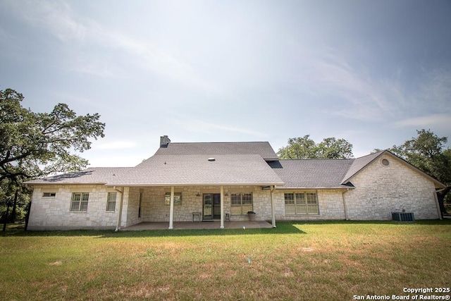 8333 Triple Crown, Boerne, TX 78015 - rear view of property featuring stone siding, a patio area, a yard, and a chimney