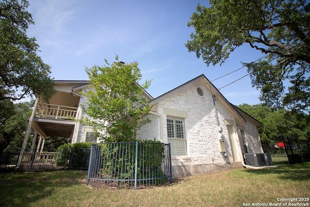 8333 Triple Crown, Boerne, TX 78015 - back of property with central AC, stone siding, and a balcony