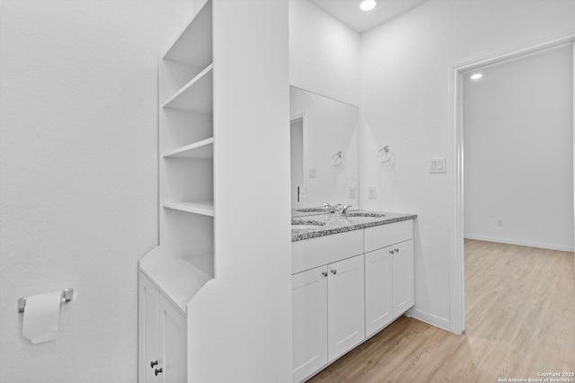 9063 Rancher, Seguin, TX 78155 - bathroom with wood finished floors, double vanity, and baseboards