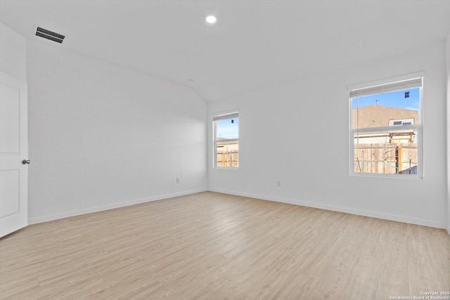 9063 Rancher, Seguin, TX 78155 - empty room featuring light wood-style flooring, baseboards, and vaulted ceiling