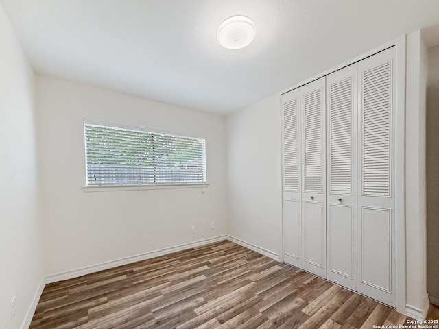 4015 Ramsgate, San Antonio, TX 78230 - unfurnished bedroom with wood finished floors, a closet, and baseboards