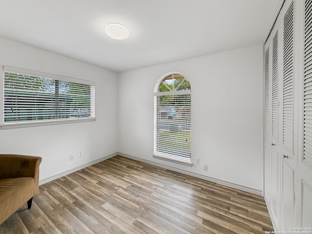 4015 Ramsgate, San Antonio, TX 78230 - unfurnished bedroom with multiple windows, wood finished floors, and a closet