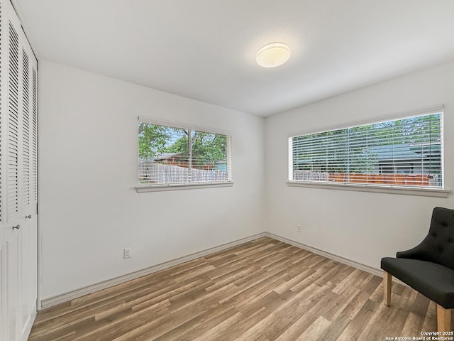 4015 Ramsgate, San Antonio, TX 78230 - unfurnished bedroom featuring wood finished floors, multiple windows, a closet, and baseboards