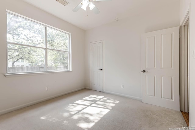 21746 Luisa, San Antonio, TX 78259 - unfurnished bedroom with light carpet, baseboards, and ceiling fan