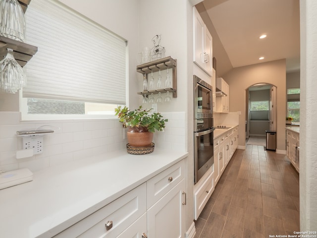 1006 Rock Shelter, San Antonio, TX 78260 - kitchen with stainless steel appliances, arched walkways, decorative backsplash, white cabinets, and recessed lighting