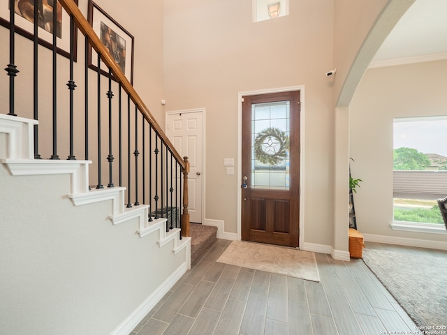 1006 Rock Shelter, San Antonio, TX 78260 - entrance foyer featuring arched walkways, plenty of natural light, baseboards, wood finish floors, and crown molding