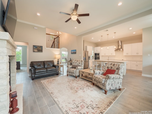 1006 Rock Shelter, San Antonio, TX 78260 - living area featuring a ceiling fan, crown molding, a stone fireplace, recessed lighting, and light wood-style floors