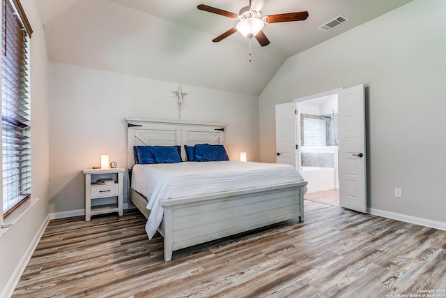 10250 Bricewood Pl, San Antonio, TX 78254 - bedroom featuring wood finished floors, vaulted ceiling, ensuite bathroom, and baseboards