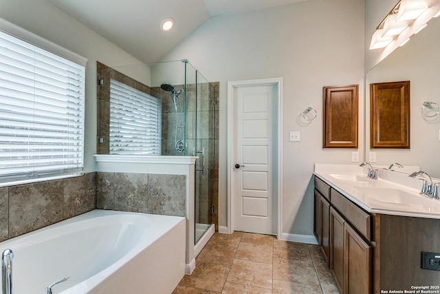 10250 Bricewood Pl, San Antonio, TX 78254 - bathroom with vaulted ceiling, a stall shower, a bath, double vanity, and baseboards