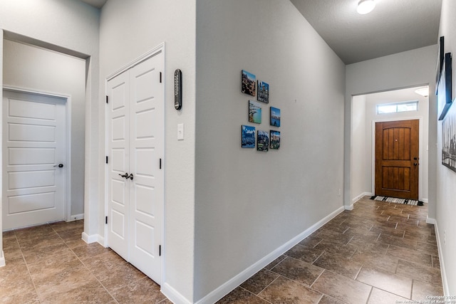 10250 Bricewood Pl, San Antonio, TX 78254 - hallway with stone tile flooring and baseboards