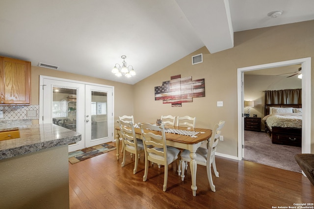 11301 Ford, Adkins, TX 78101 - dining room with dark wood finished floors, lofted ceiling, french doors, a chandelier, and baseboards