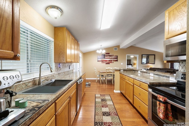 11301 Ford, Adkins, TX 78101 - kitchen with appliances with stainless steel finishes, a sink, light wood-style floors, a chandelier, and decorative backsplash