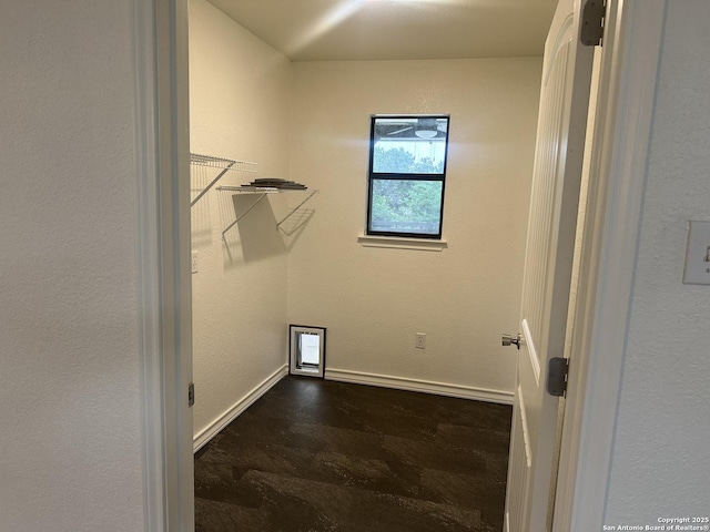 185 Quail Valley Dr, Bandera, TX 78003 - laundry room featuring dark wood-style flooring and baseboards