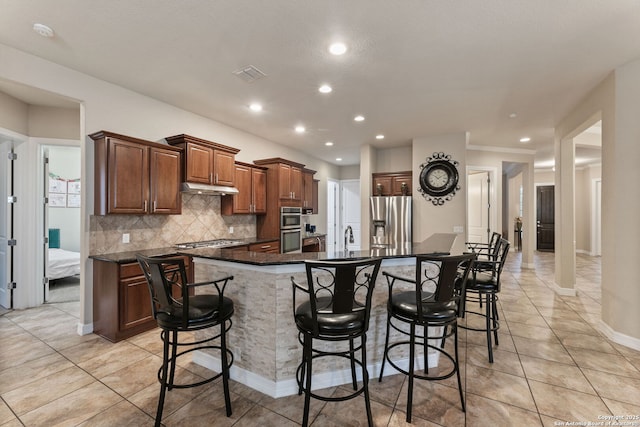 12234 Prince Solms, San Antonio, TX 78253 - kitchen with stainless steel appliances, light tile patterned floors, recessed lighting, a breakfast bar, and backsplash