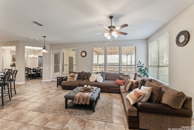 12234 Prince Solms, San Antonio, TX 78253 - living room with a ceiling fan, a chandelier, light tile patterned floors, and baseboards