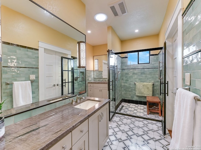 207 Queen Anne, San Antonio, TX 78209 - full bath featuring tile walls, tile patterned floors, vanity, a stall shower, and recessed lighting