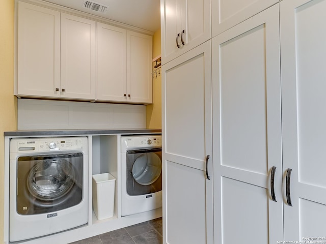 207 Queen Anne, San Antonio, TX 78209 - laundry area with washer and clothes dryer, cabinet space, and dark tile patterned flooring